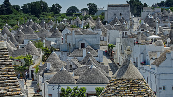 The fabulous city of Alberobello. Trulli houses with conical roofs and mysterious signs.