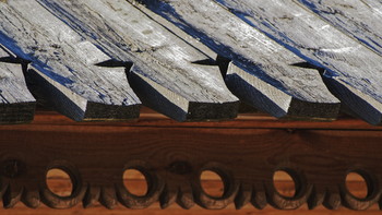 Carved wooden end of the roof.