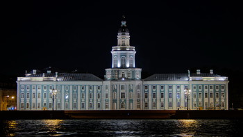 The building of the Kunstkamera on the Neva embankment in the night light. Center of old Saint Petersburg.