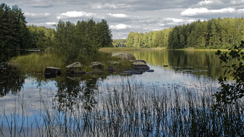 The lakes of Russia, blue as the sky, framed by a green forest.