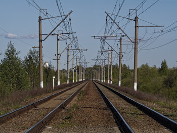 The rails of the railway run away over the horizon